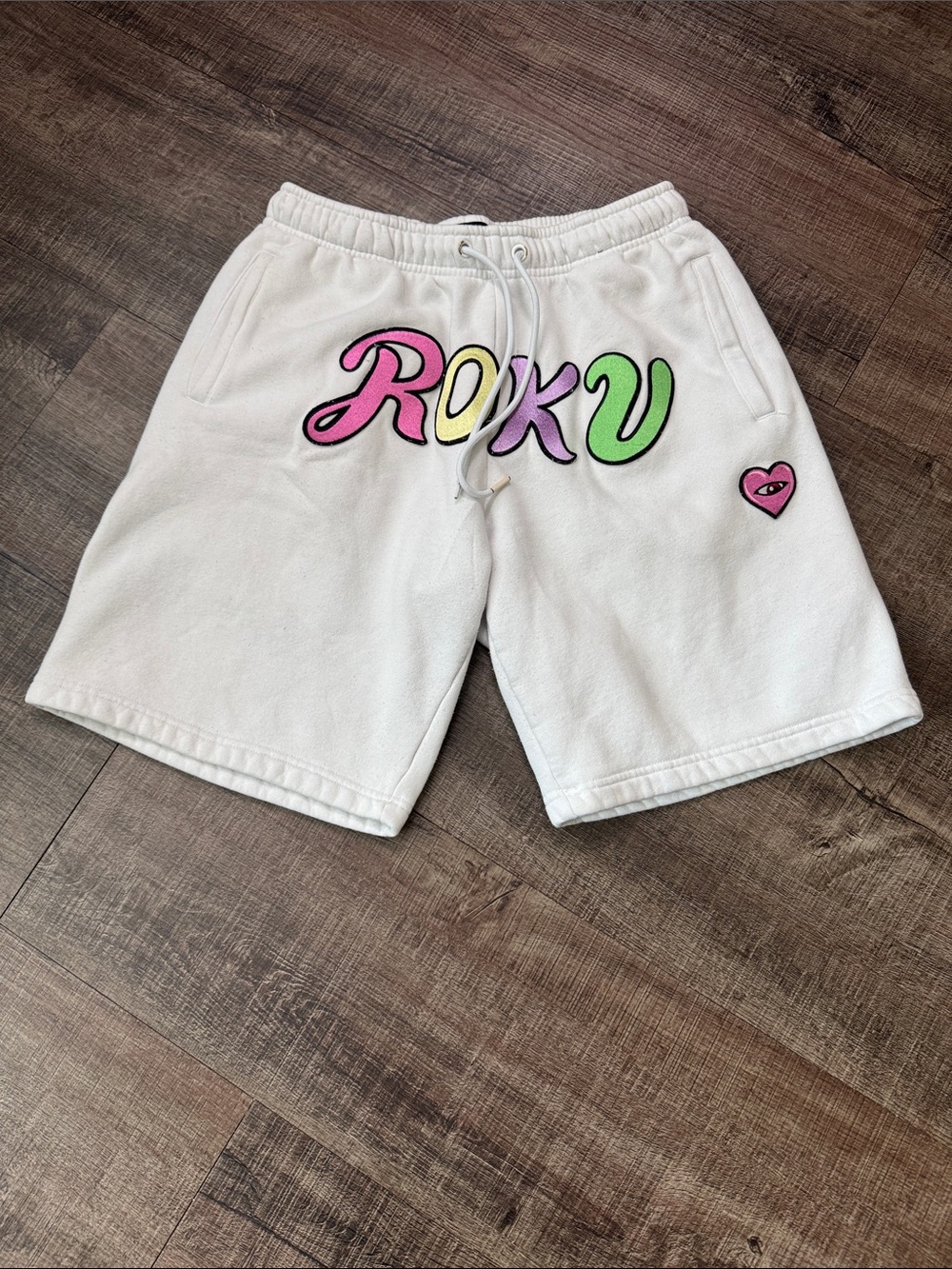Roku White Sweatshorts with Pink, Yellow, Lavender and Green Logo